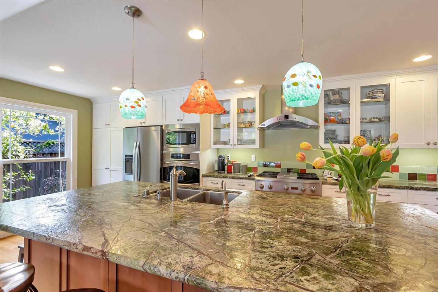 10181 Phar Lap Drive Cupertino, CA 95014 - Photo 3 of 9 a view of a kitchen with dining table and chairs