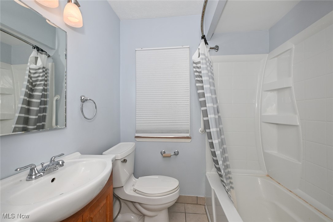 4166 Verona Road Cleveland, OH 44121 - Photo 36 of 43 Full bathroom with vanity, tile patterned floors, toilet, and shower / tub combo