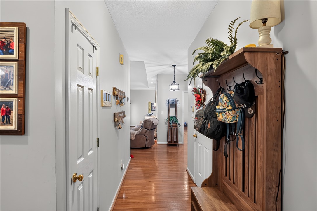 144 Elliott Circle Anderson, SC 29621 - Photo 2 of 30 A welcoming entryway hallway offers polished hardwood flooring leading to a cozy living space.