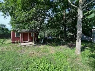 a view of backyard of house with green space