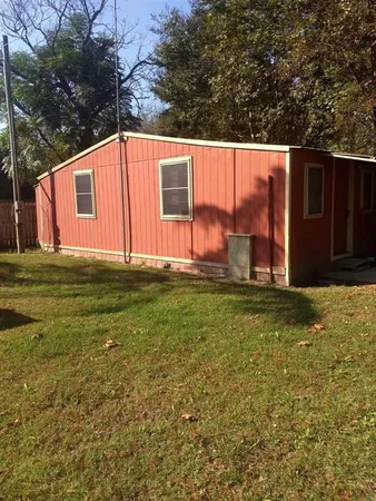 a view of a backyard with large trees