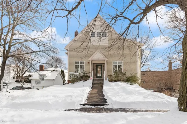 a view of a white house with a yard covered in snow