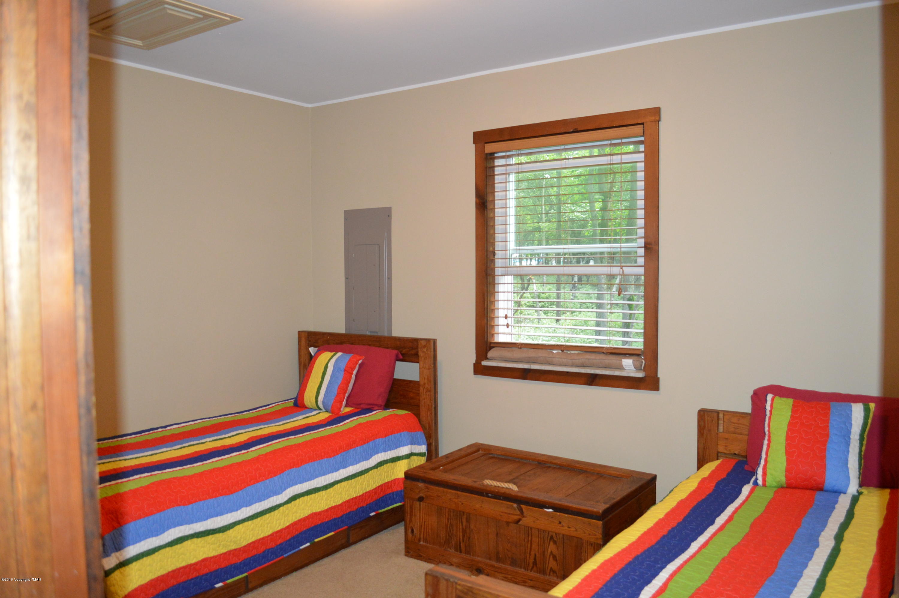 256 Fern Ridge Road Blakeslee, PA 18610 - Photo 18 of 27 a room with a bed and a chair
