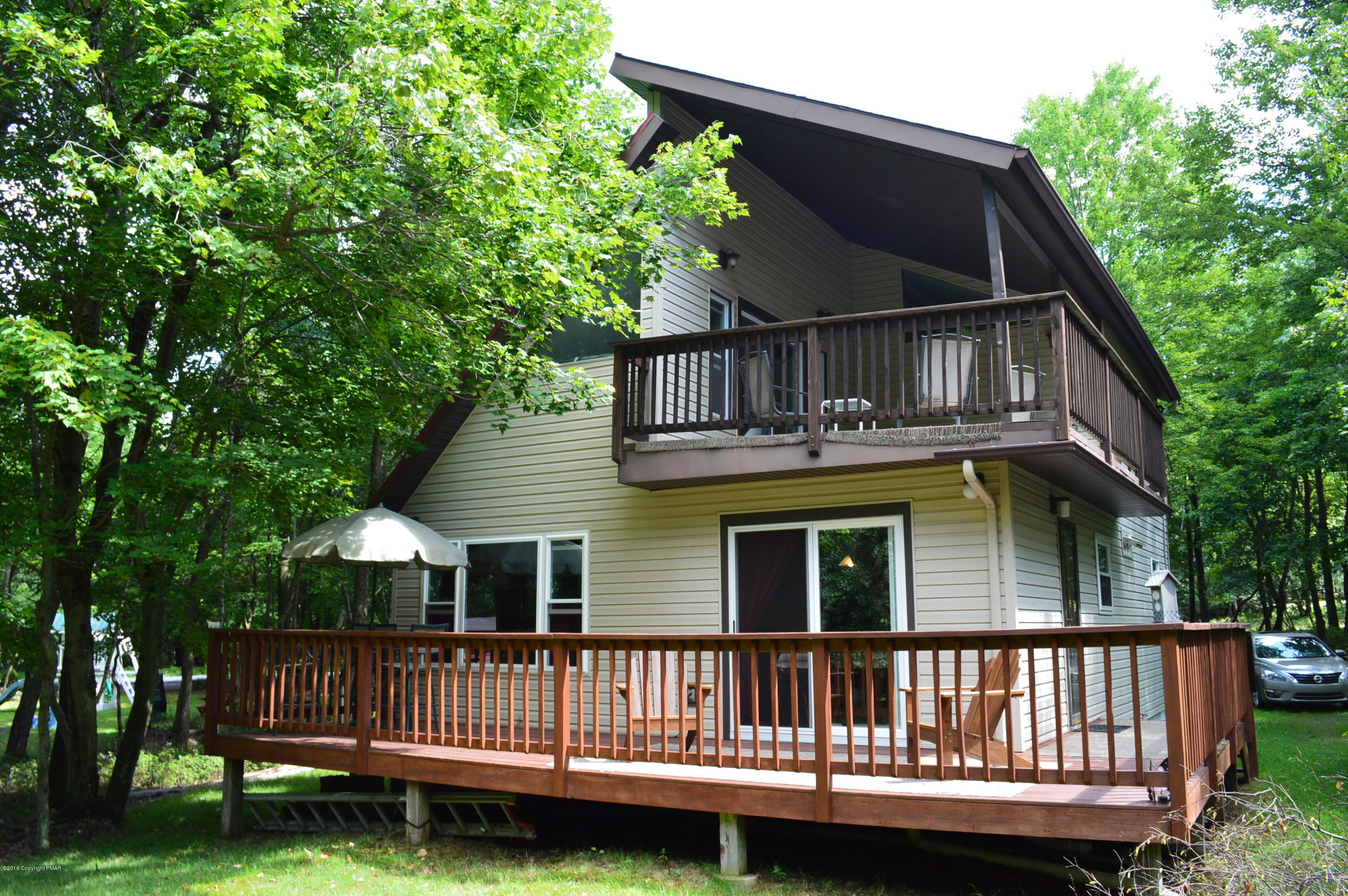 256 Fern Ridge Road Blakeslee, PA 18610 - Photo 22 of 27 a view of a house with a wooden deck