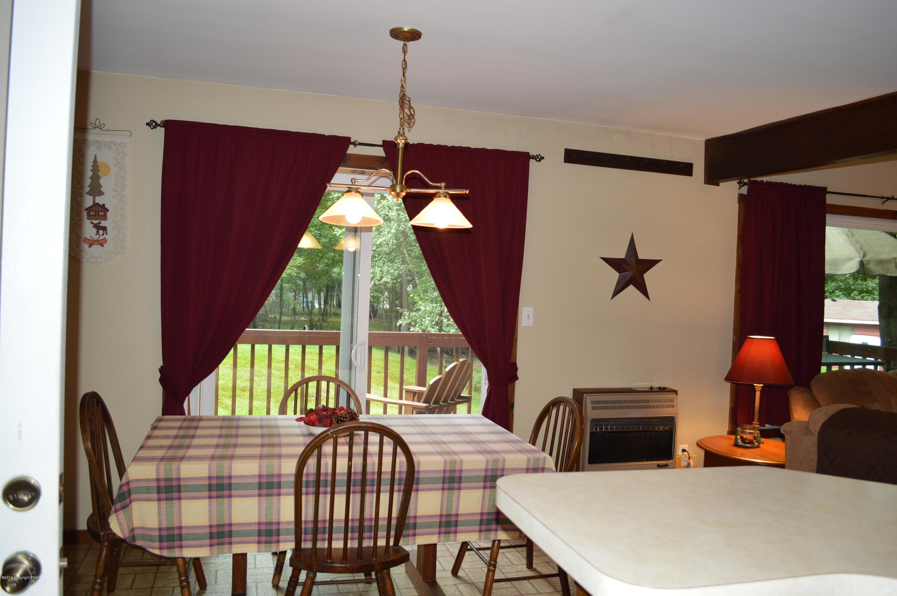 256 Fern Ridge Road Blakeslee, PA 18610 - Photo 3 of 27 a dining room with furniture and a chandelier