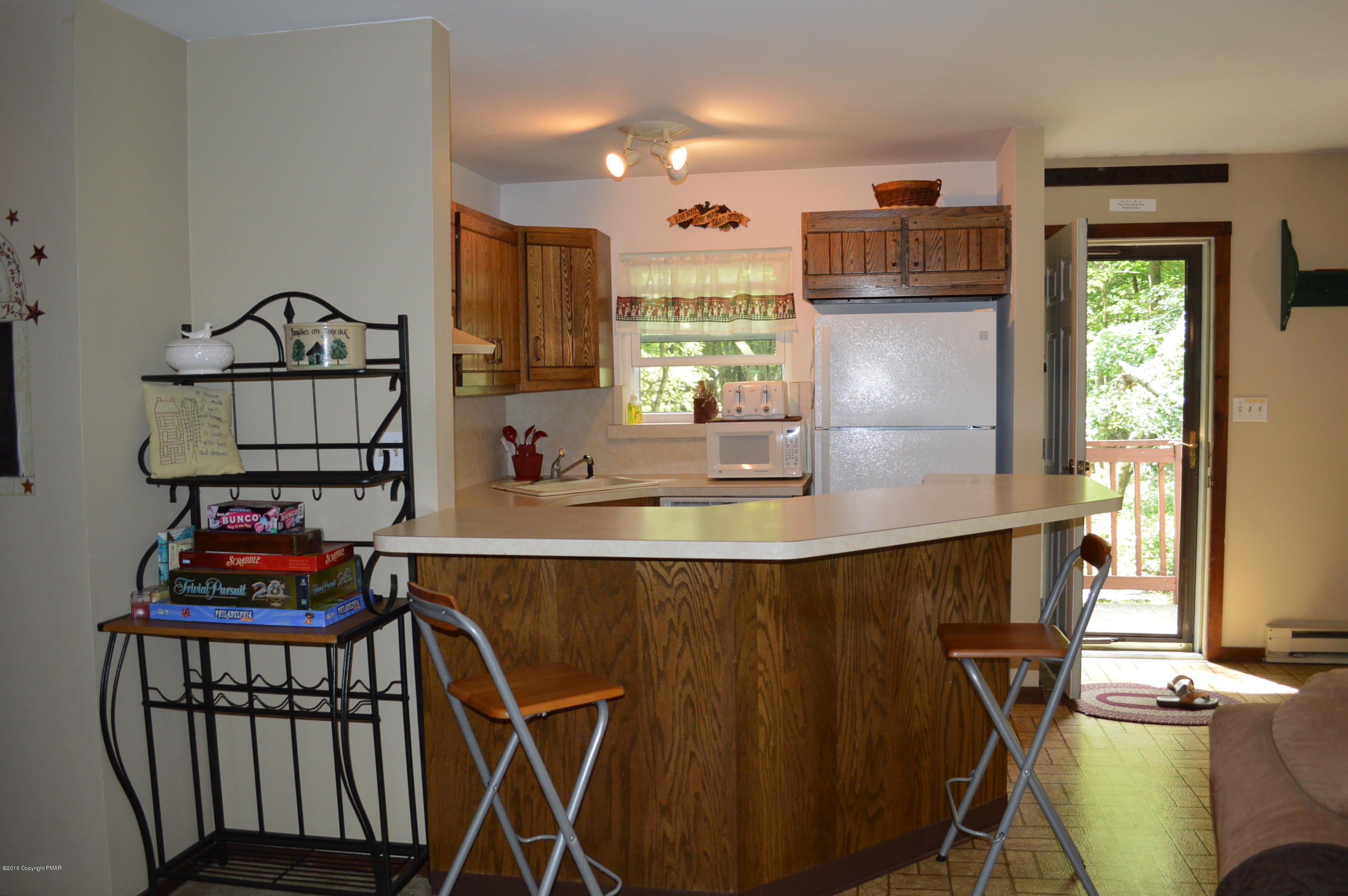 256 Fern Ridge Road Blakeslee, PA 18610 - Photo 4 of 27 a kitchen with stainless steel appliances a sink cabinets and a table