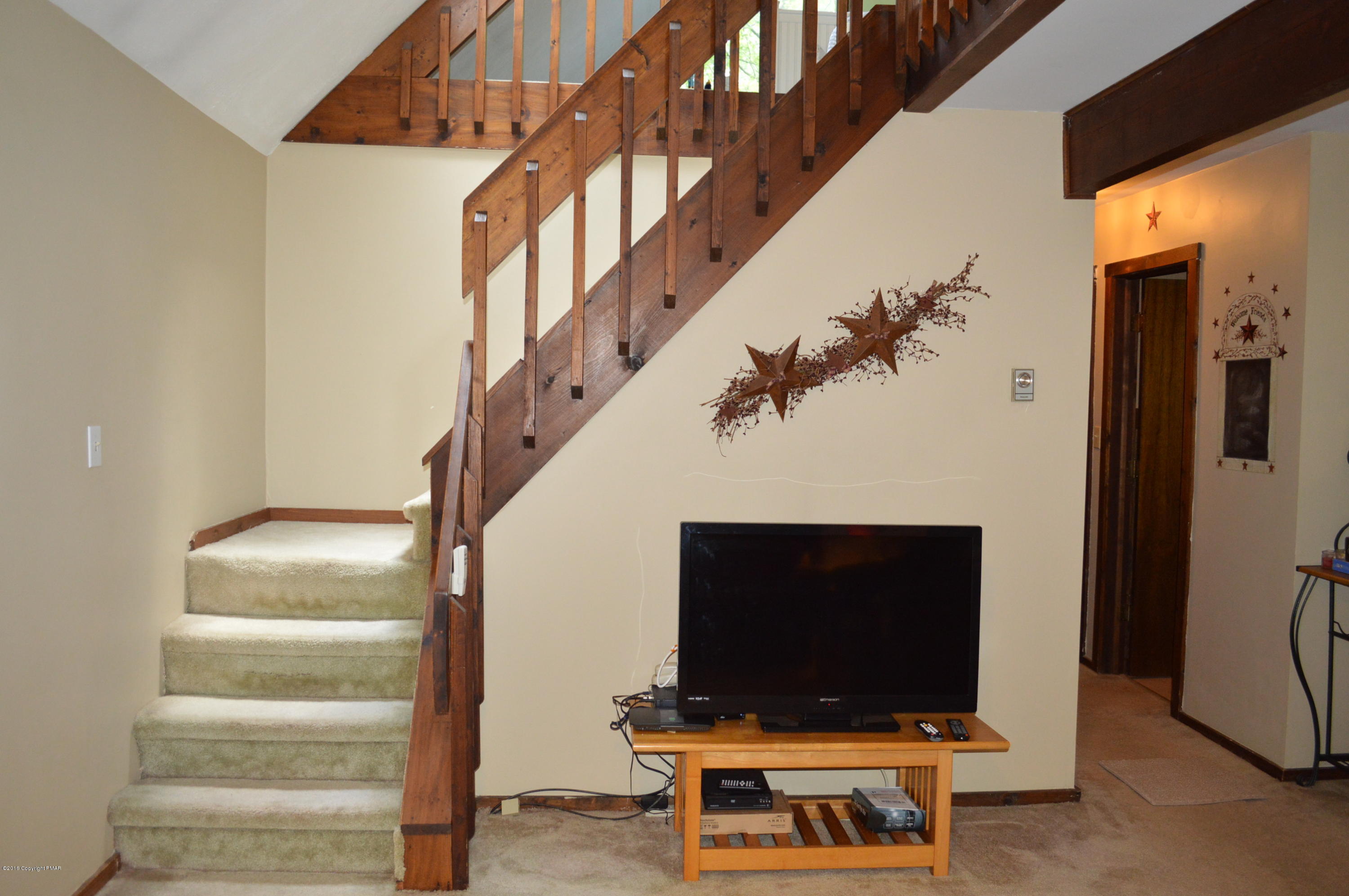 256 Fern Ridge Road Blakeslee, PA 18610 - Photo 8 of 27 a living room with a flat screen tv and a table