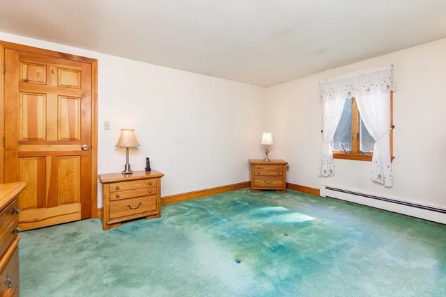a view of an empty room with cabinet and stairs