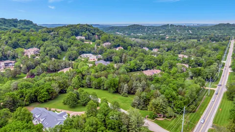 an aerial view of a houses with a yard