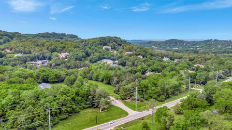 an aerial view of mountain with trees in the background
