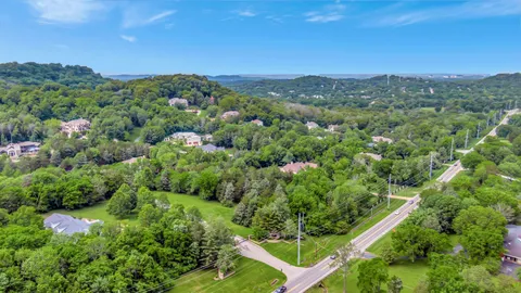 a view of a city with lush green forest