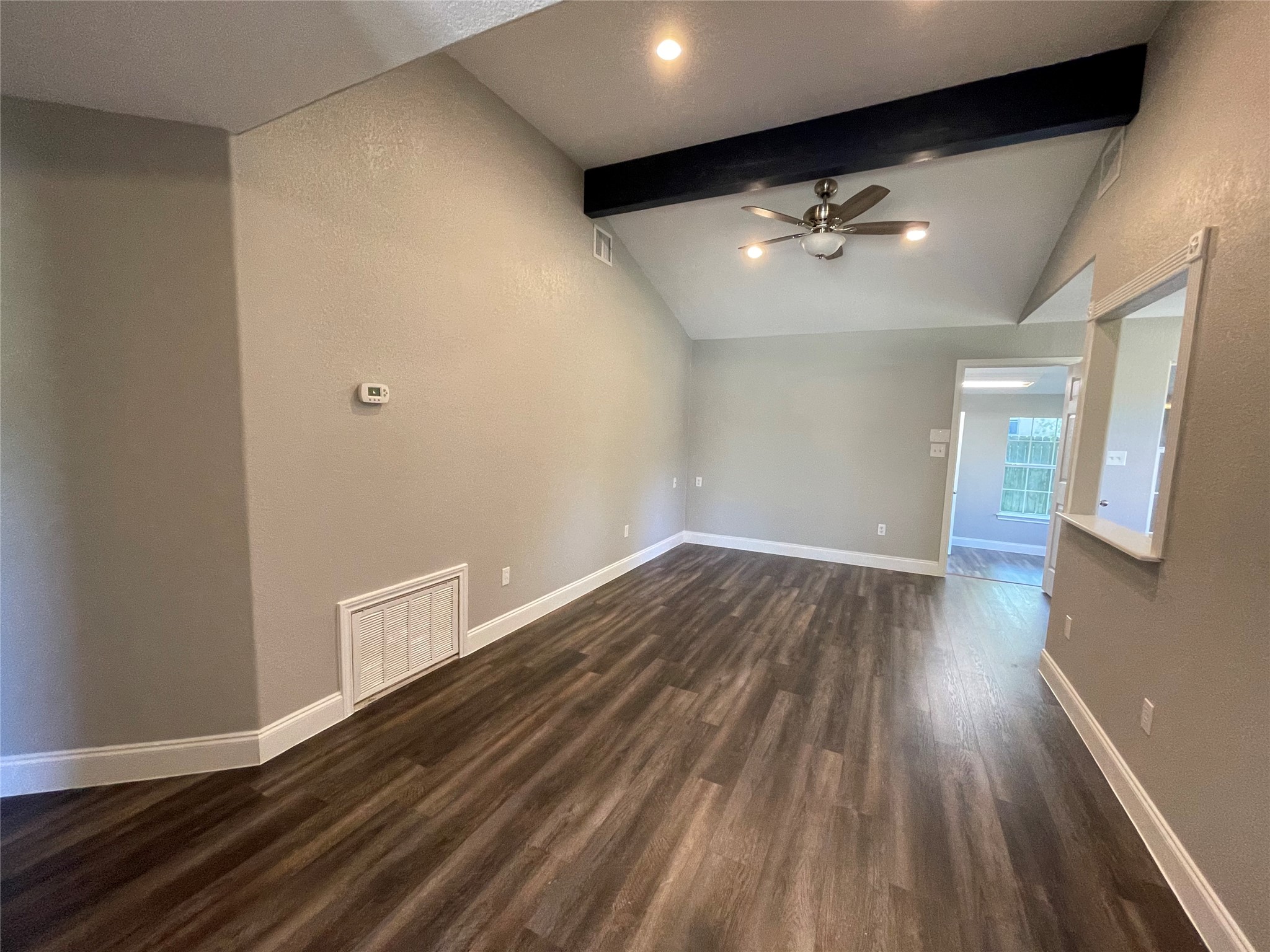 2004 Maple Street Georgetown, TX 78626 - Photo 15 of 31 Spacious room featuring vaulted ceilings with an exposed dark beam, recessed lighting, and a ceiling fan