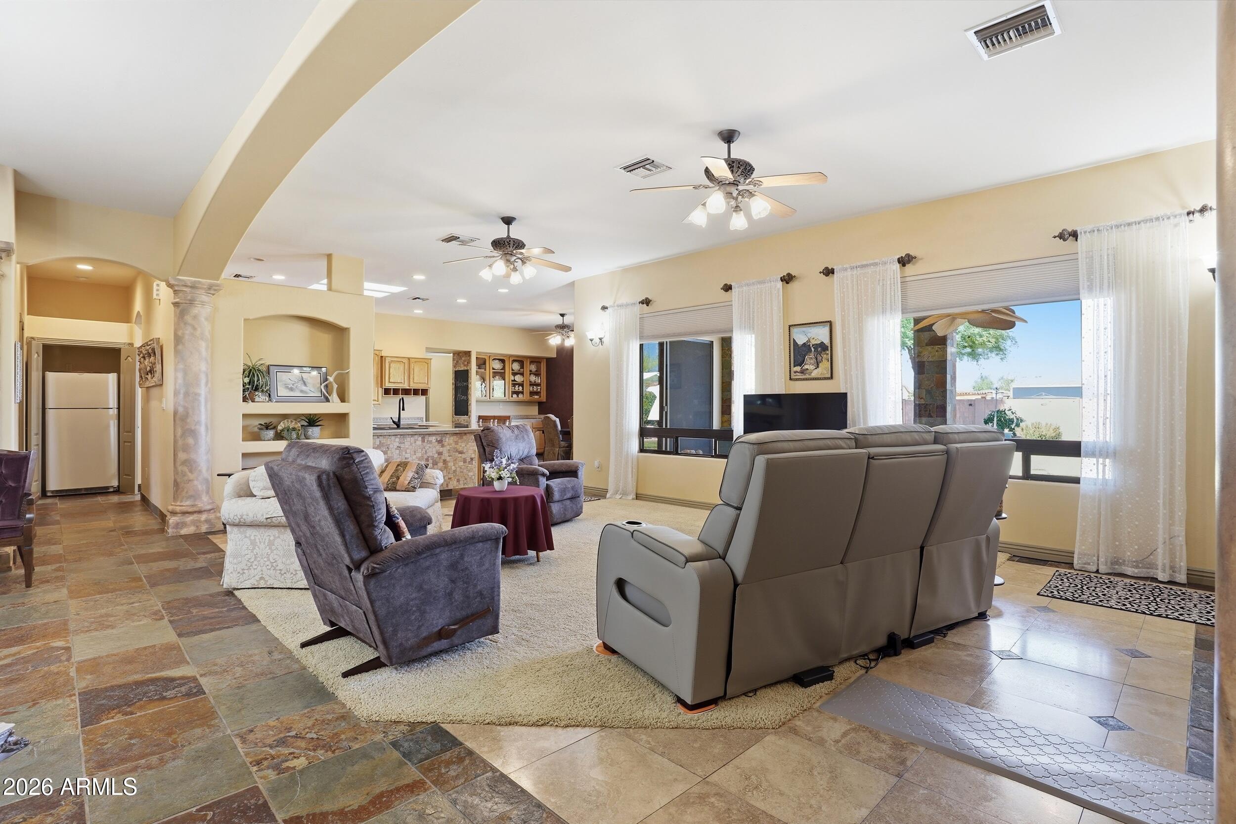 6334 East Albany Street Mesa, AZ 85205 - Photo 14 of 72 a living room with furniture kitchen view and a chandelier