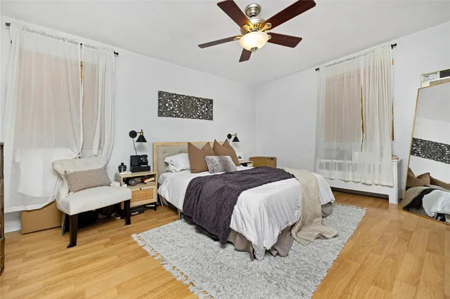 a spacious bedroom with a bed and a chandelier