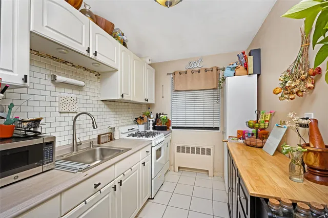 a kitchen that has a sink and cabinets