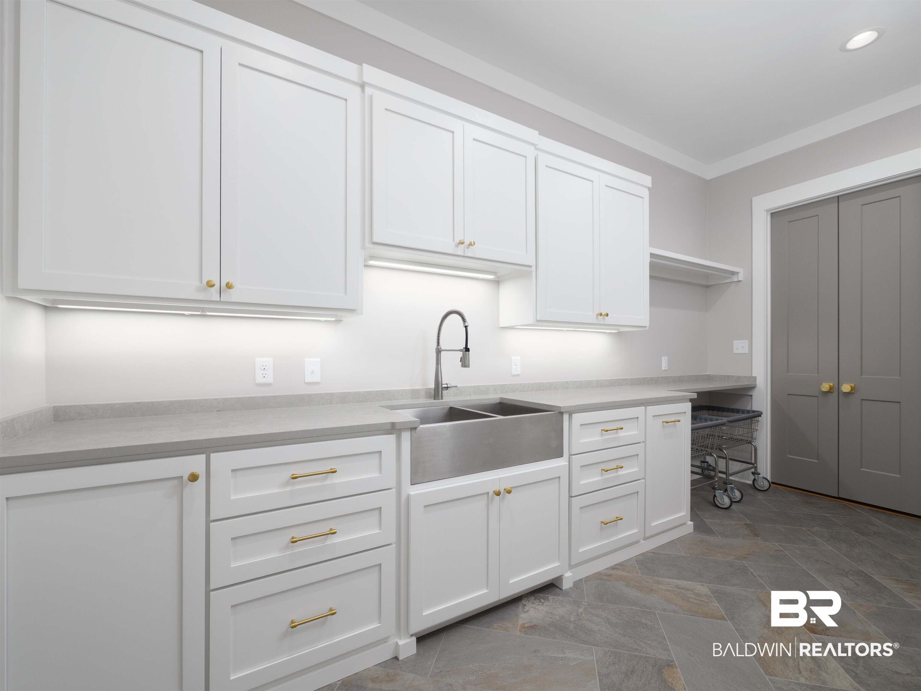 10912 Catania Avenue Fairhope, AL 36532 - Photo 26 of 54 Laundry room that features a standing folding area/basket keep, room for a second refrigerator, and custom cabinetry throughout