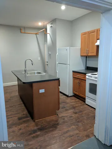 a kitchen with stainless steel appliances granite countertop a sink a counter space and cabinets