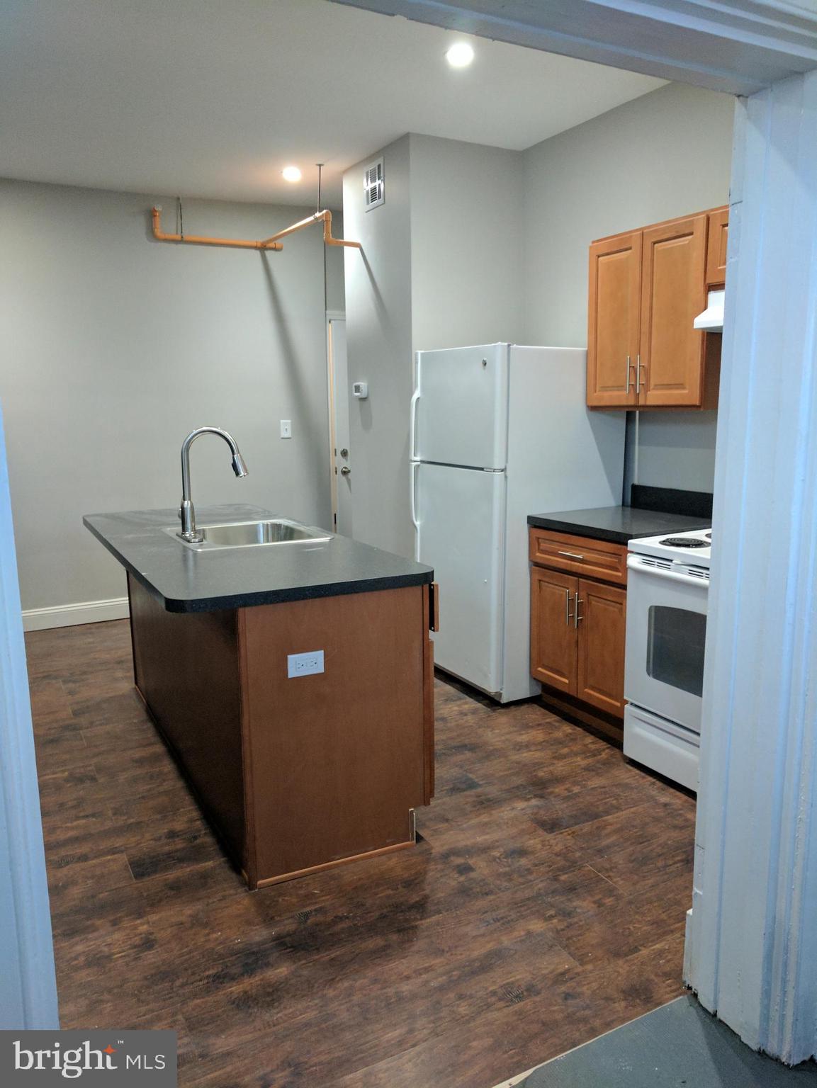 399 West State Street Trenton, NJ 08618 - Photo 12 of 28 a kitchen with stainless steel appliances granite countertop a sink a counter space and cabinets