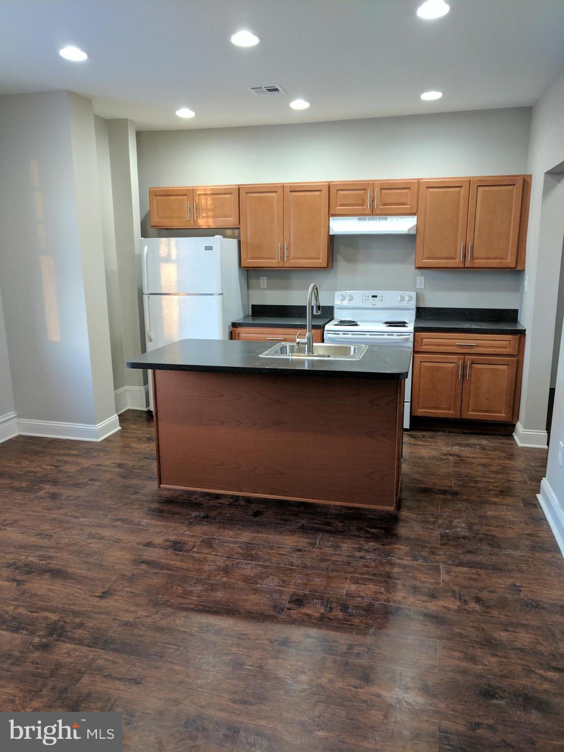 399 West State Street Trenton, NJ 08618 - Photo 15 of 28 a kitchen with stainless steel appliances granite countertop a stove a sink and a refrigerator