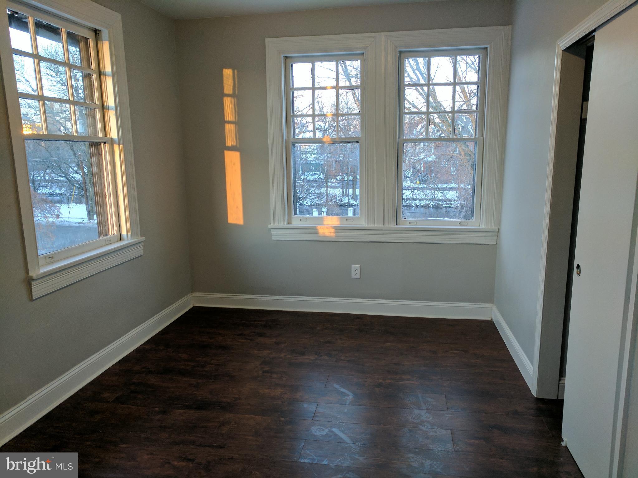 399 West State Street Trenton, NJ 08618 - Photo 18 of 28 an empty room with wooden floor and windows