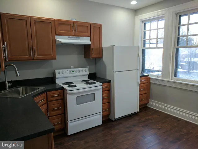 a kitchen with a stove and a refrigerator