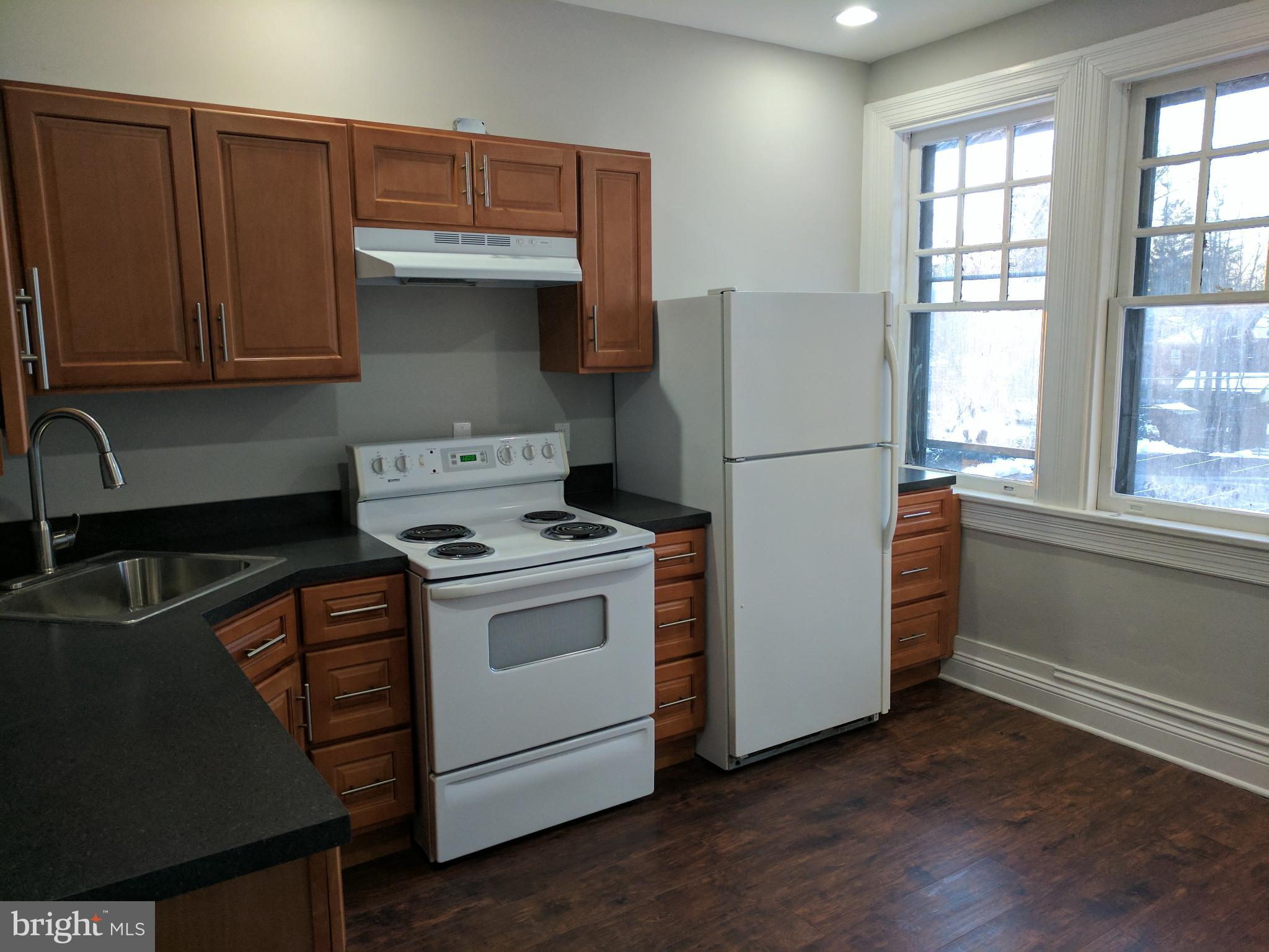 399 West State Street Trenton, NJ 08618 - Photo 21 of 28 a kitchen with a stove and a refrigerator
