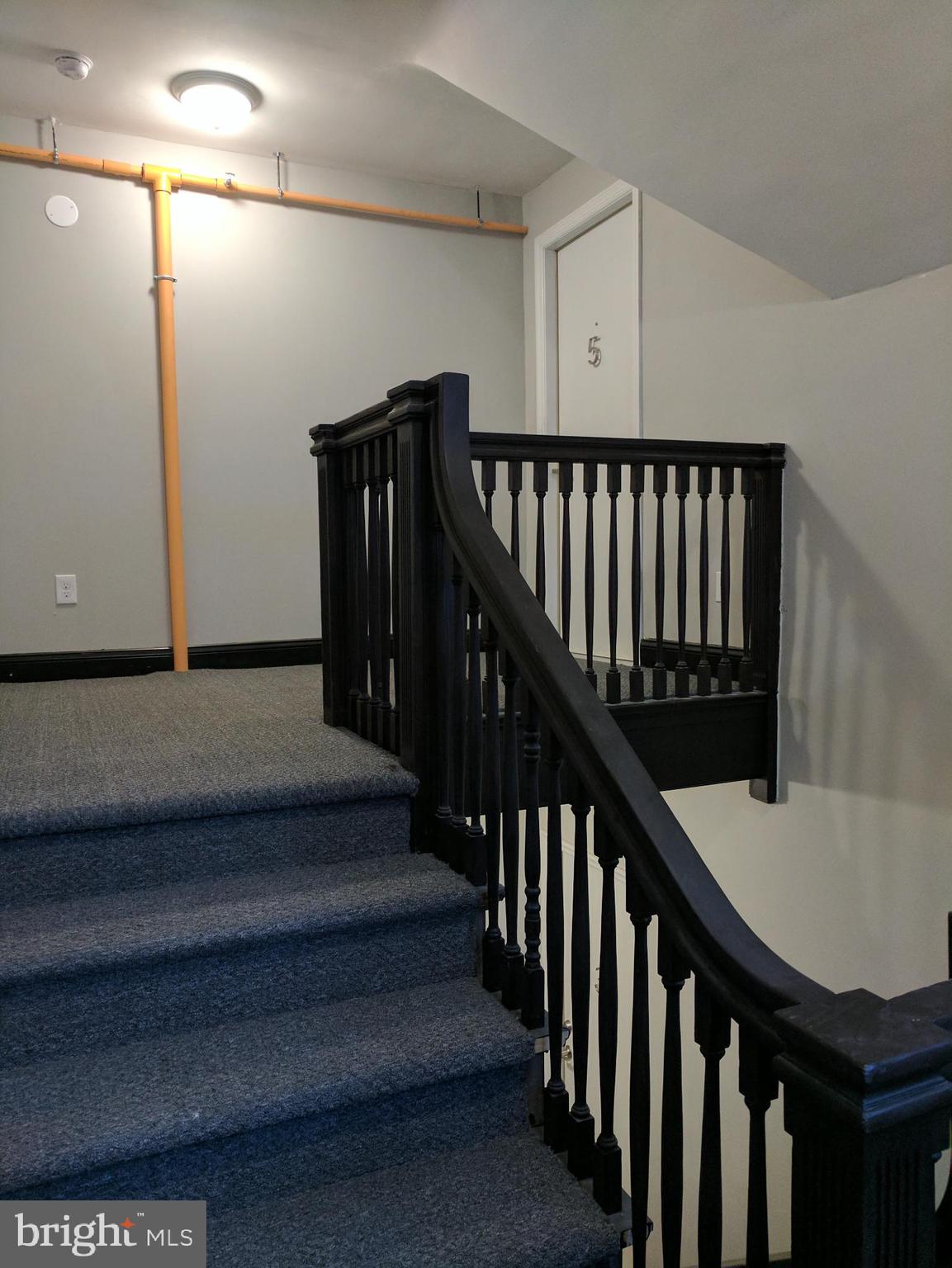 399 West State Street Trenton, NJ 08618 - Photo 23 of 28 a view of staircase with lots of frames on wall and wooden floor