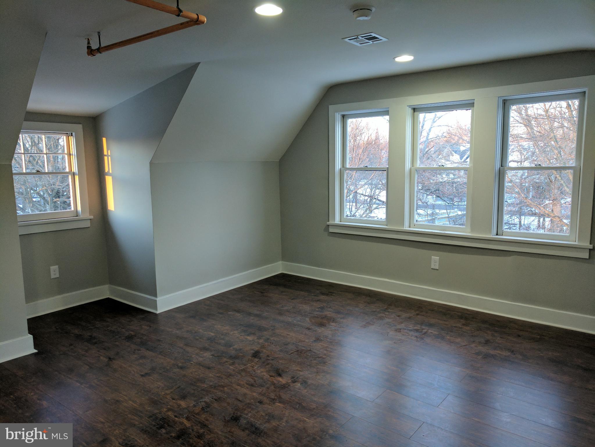 399 West State Street Trenton, NJ 08618 - Photo 24 of 28 an empty room with wooden floor and windows
