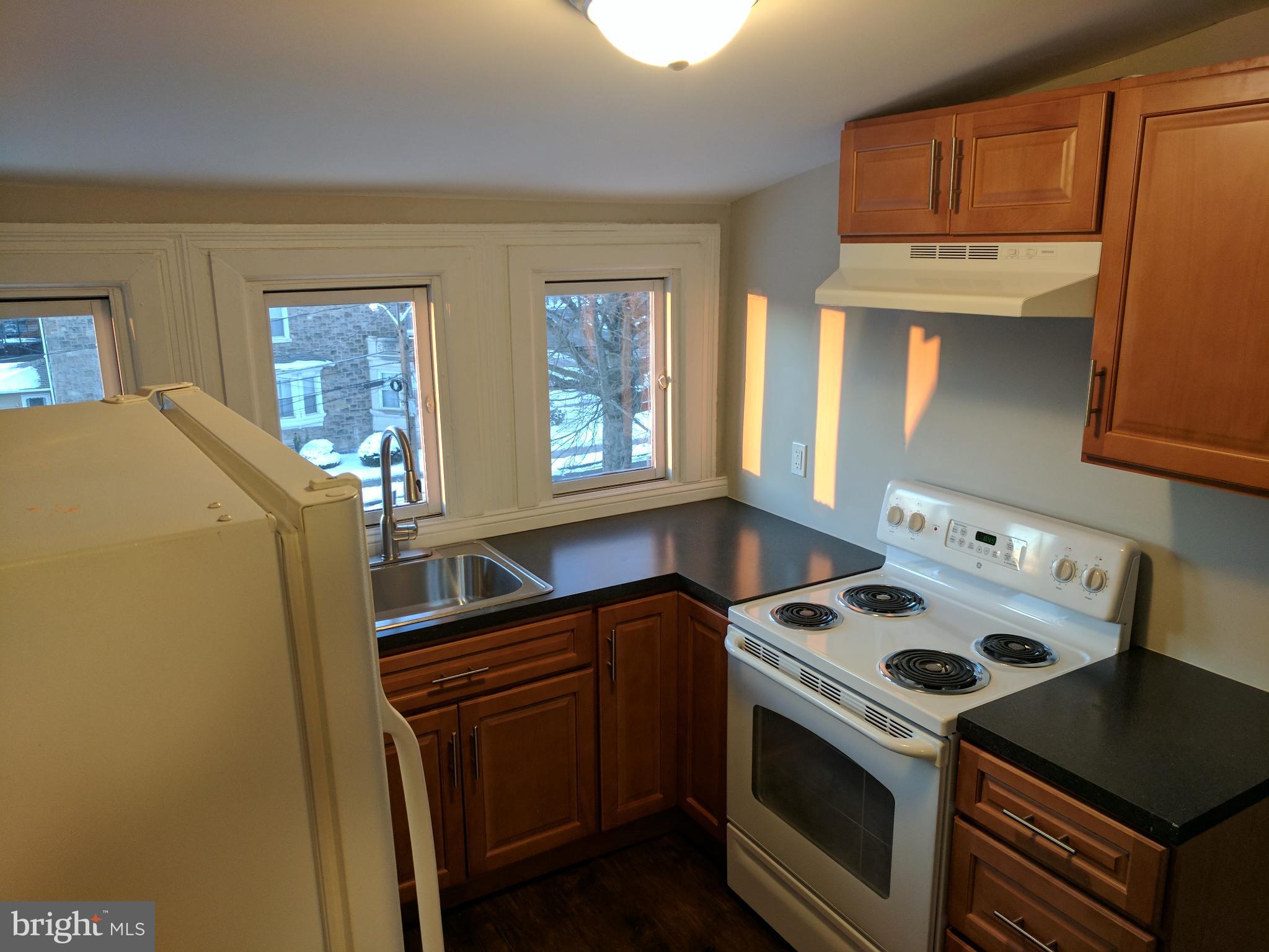399 West State Street Trenton, NJ 08618 - Photo 26 of 28 a kitchen with a stove and a refrigerator