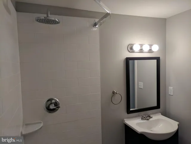 a bathroom with a sink mirror and vanity