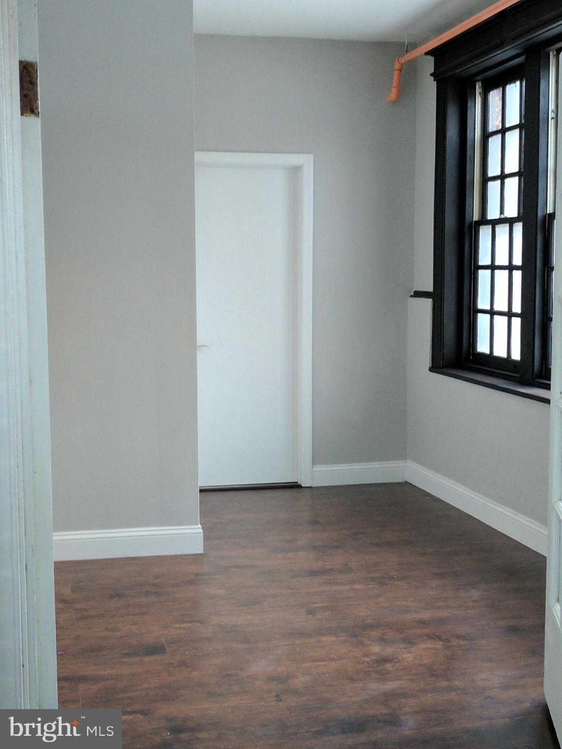 399 West State Street Trenton, NJ 08618 - Photo 9 of 28 a view of an empty room with wooden floor and a window