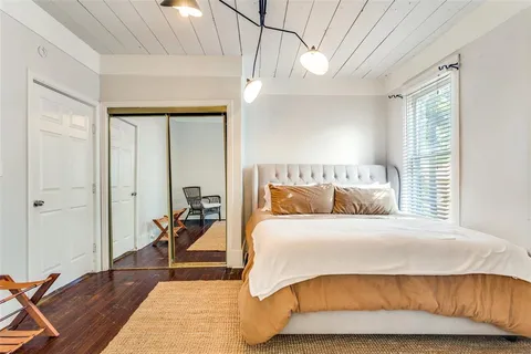 a bedroom with a bed and a mirror