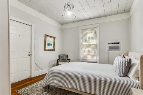 a bedroom with a large bed and a window