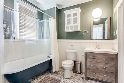 a bathroom with a toilet a sink and mirror