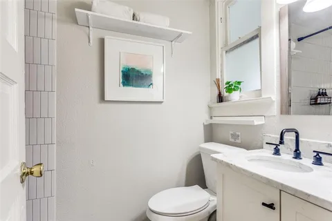 a bathroom with a toilet sink and mirror