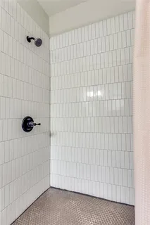 a view of a bedroom with wooden floor and a balcony