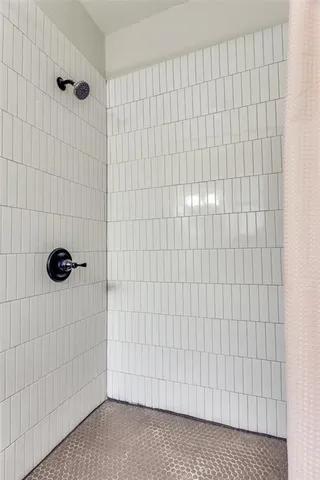 a view of a bedroom with wooden floor and a balcony