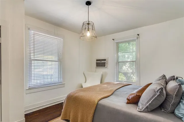a bedroom with a bed and a chandelier