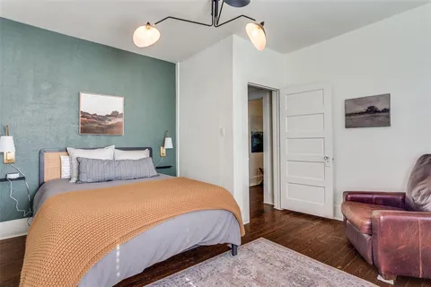 a view of a backyard with chairs potted plants and wooden fence
