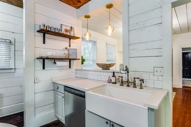 a kitchen with a sink cabinets and appliances