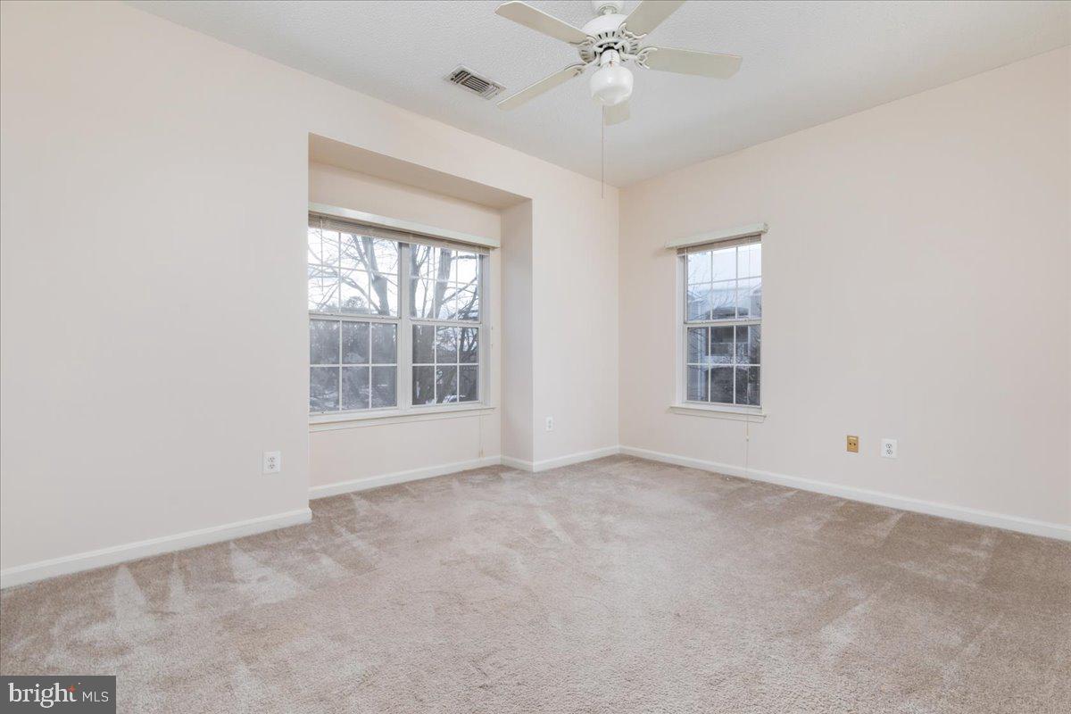 1705 Lake Shore Crest Drive, Unit 25 Reston, VA 20190 - Photo 12 of 31 an empty room with windows and fan