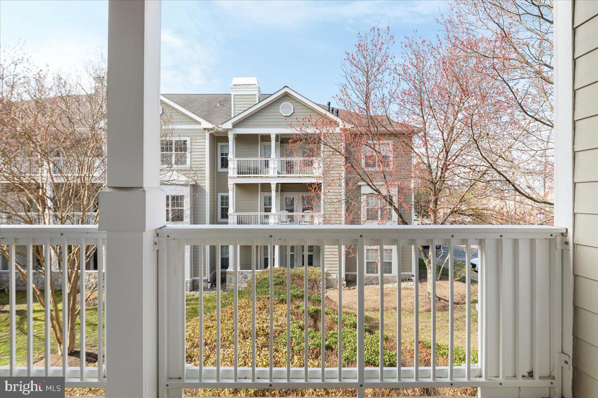 1705 Lake Shore Crest Drive, Unit 25 Reston, VA 20190 - Photo 21 of 31 a front view of a house with a yard