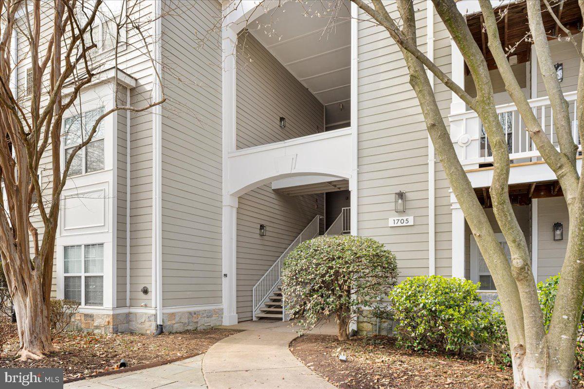 1705 Lake Shore Crest Drive, Unit 25 Reston, VA 20190 - Photo 28 of 31 a view of a house with a yard