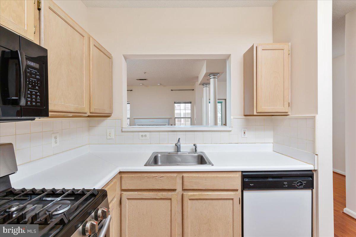 1705 Lake Shore Crest Drive, Unit 25 Reston, VA 20190 - Photo 10 of 31 a kitchen with white cabinets and a stove top oven