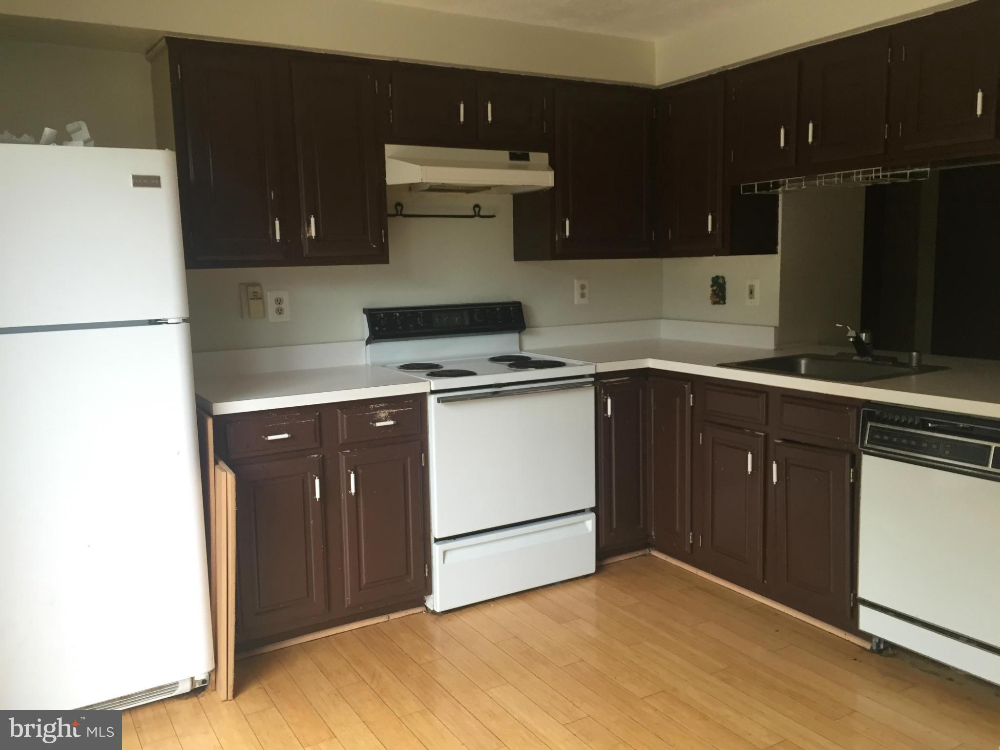 2211 Riding Crop Way Baltimore, MD 21244 - Photo 8 of 20 a kitchen with a cabinets and white appliances
