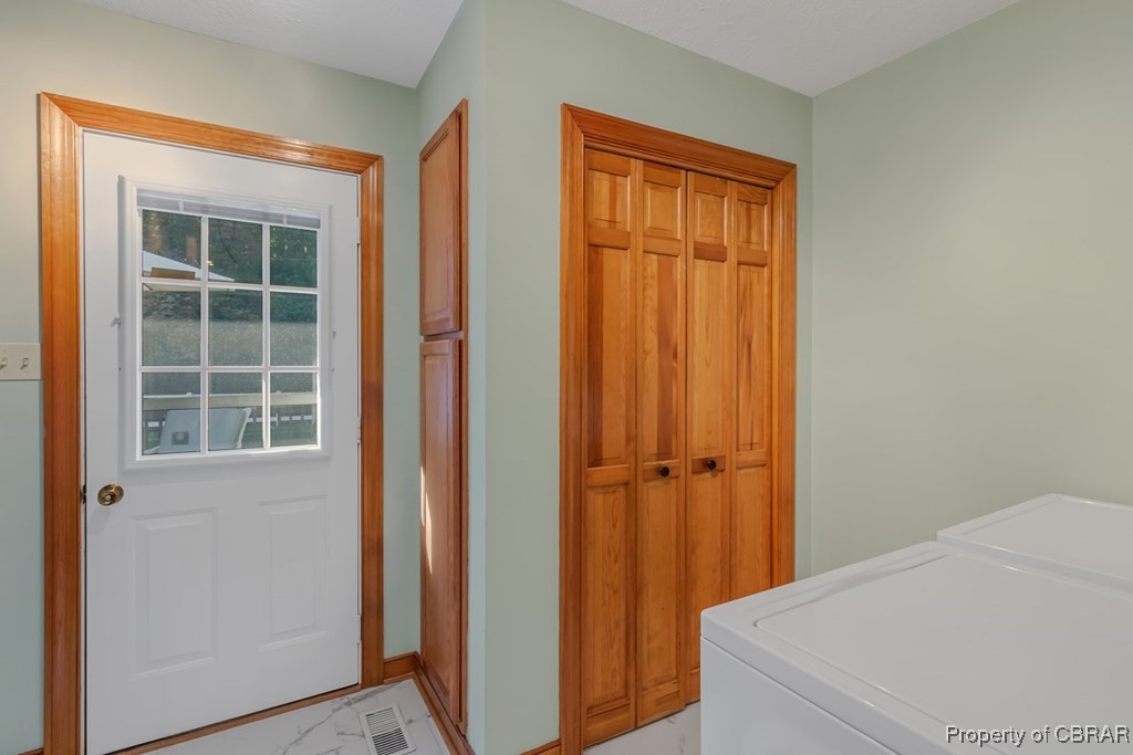 35 Powhatan Road Kilmarnock, VA 22482 - Photo 20 of 42 Clothes washing area with marble finish floor, independent washer and dryer, visible vents, and laundry area