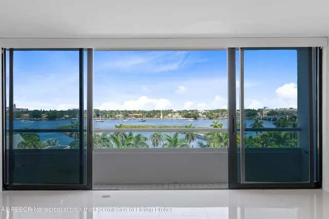 a spacious bedroom with a bed and a large window