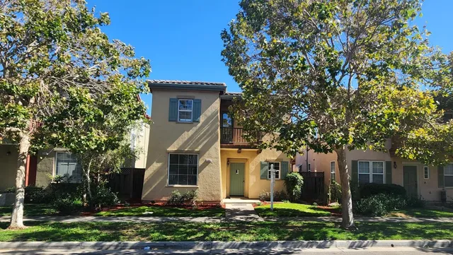 front view of a house with a tree