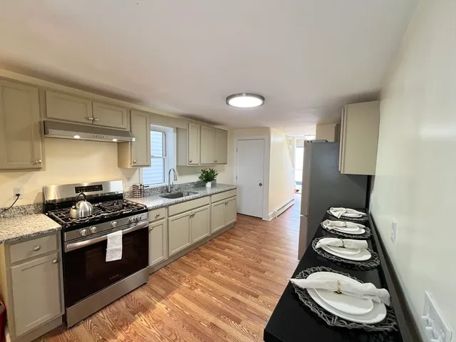 a kitchen with stainless steel appliances granite countertop a stove and a sink