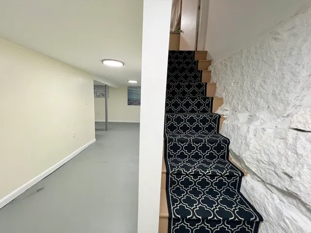 a view of a room with gym equipment and mirrors